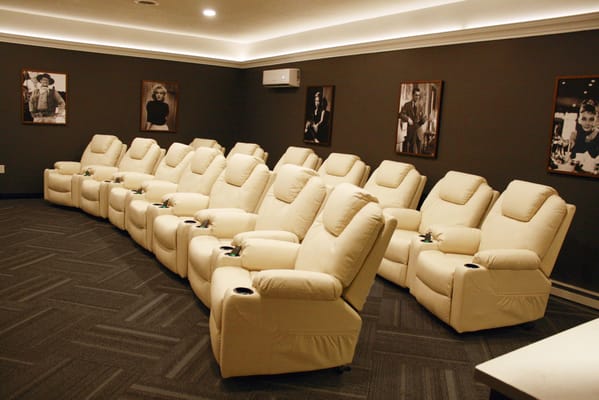 A cozy movie theater room with reclining seats