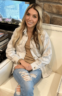 A young woman sitting in a cozy lounge chair