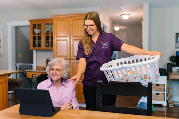 Staff assisting a resident at a dining table