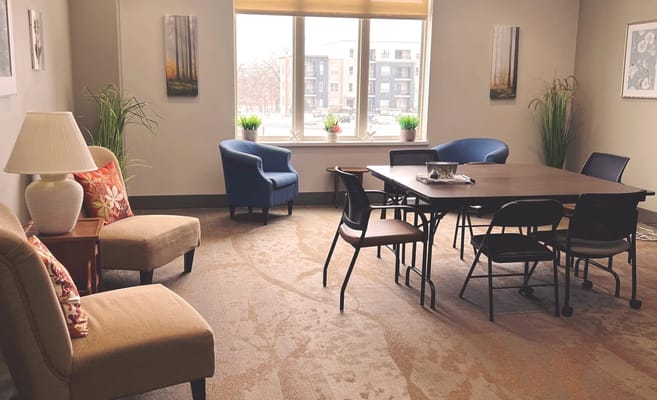 Bright common area with chairs and table