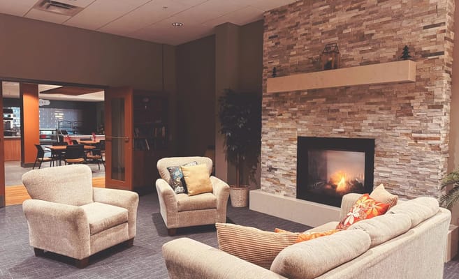 Cozy common area with comfortable seating and a fireplace