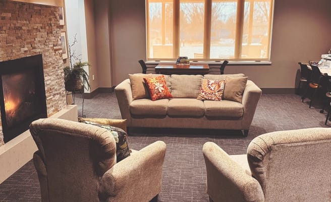 Cozy common area with a sofa and armchairs