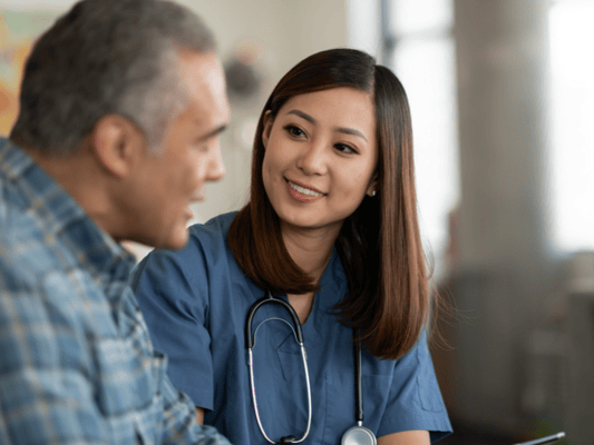 Healthcare worker smiling with resident during conversation
