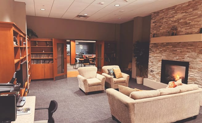 Comfortable lounge area with seating and a fireplace