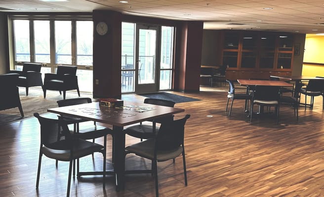 Common area with tables and seating in a bright space