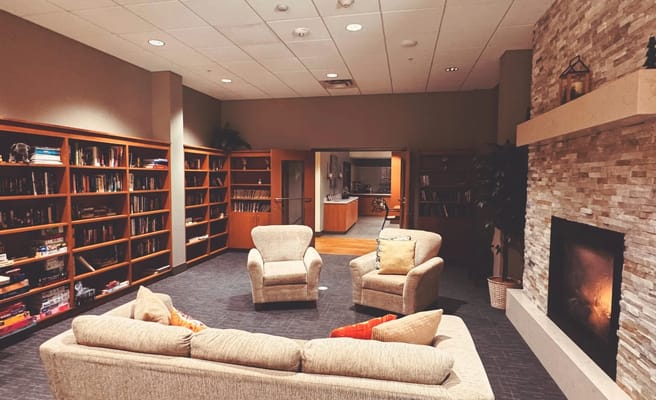 Cozy lounge area with bookshelves and seating