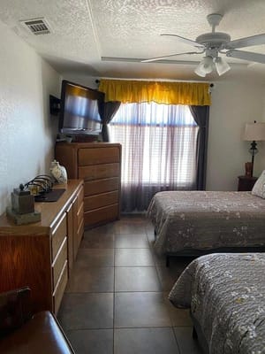 Interior view of a resident room with two beds and a TV