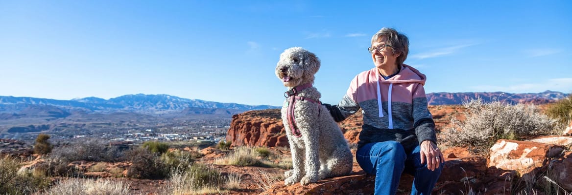 Senior woman enjoying nature with her dog