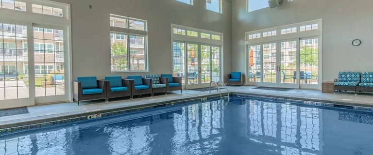 Indoor pool area with seating and large windows