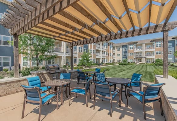 Outdoor patio area with seating and grill