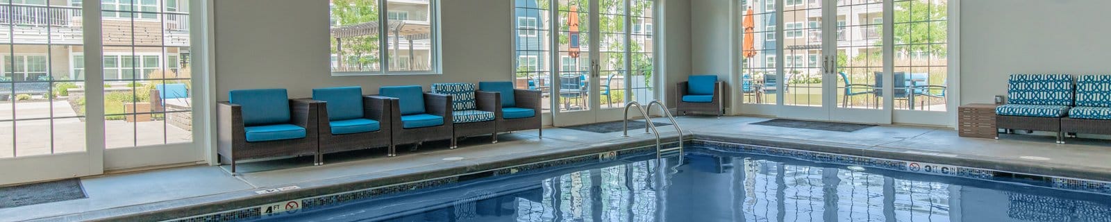 Indoor swimming pool area with comfortable seating