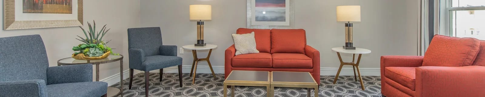 Cozy common area with comfortable seating and lamps