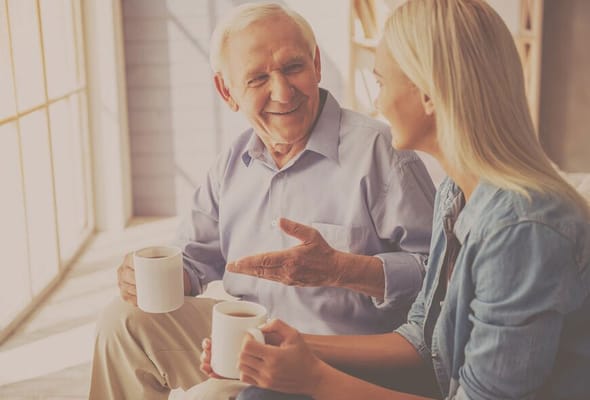 A senior man and a woman enjoying coffee and conversation