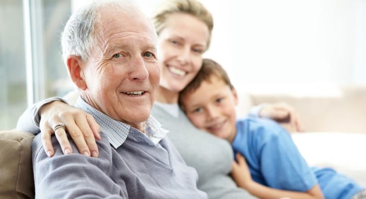 A senior man posing with family members