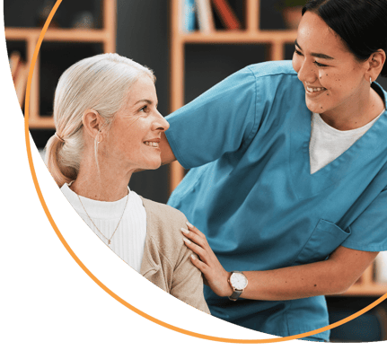 A healthcare worker assisting a senior resident