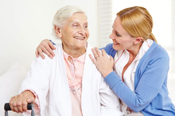 Staff member interacting joyfully with a resident
