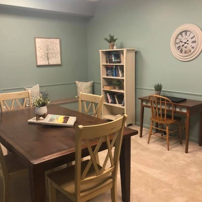 Cozy common area with bookshelves and a meeting table