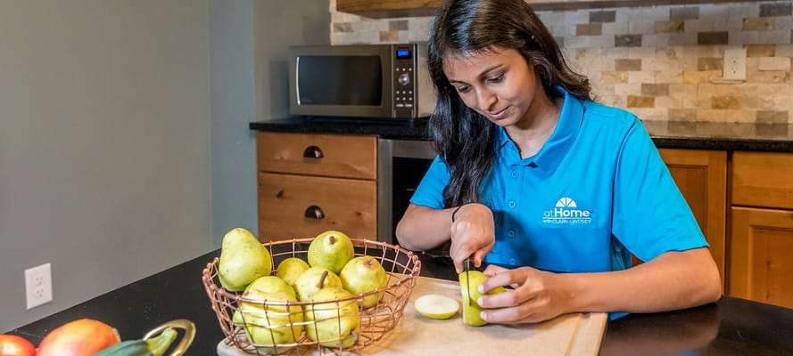 Staff member preparing food in a kitchen