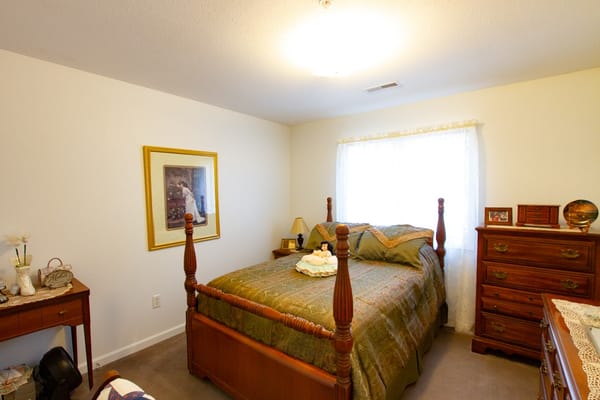 Cozy resident room with a bed and dresser