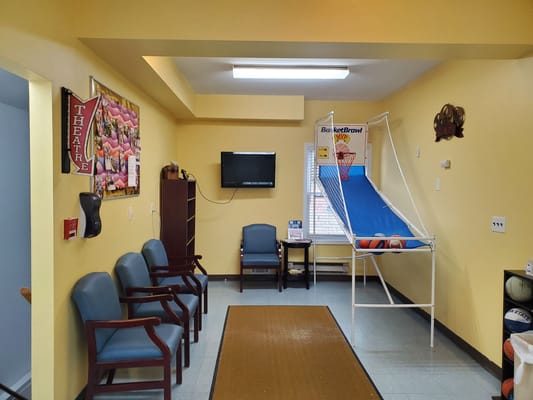 Interior activity room with seating and game