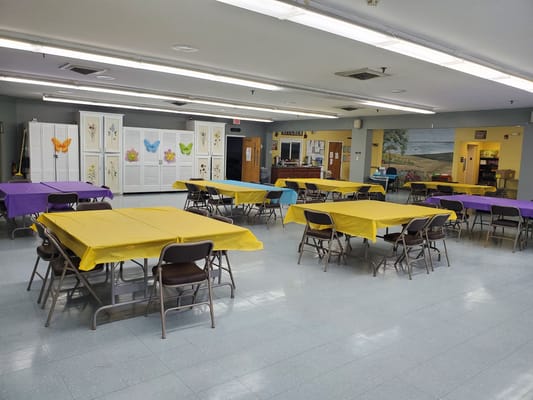Brightly colored tables set up for an event in a common area