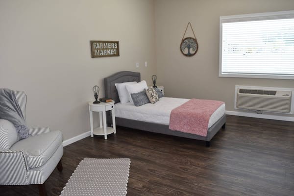 A private resident room with a bed and decor