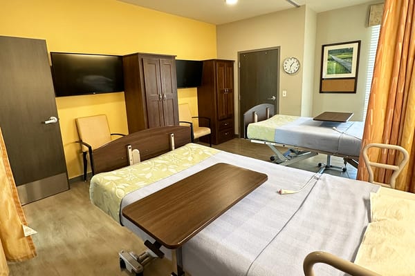 Interior of a shared resident room with hospital beds