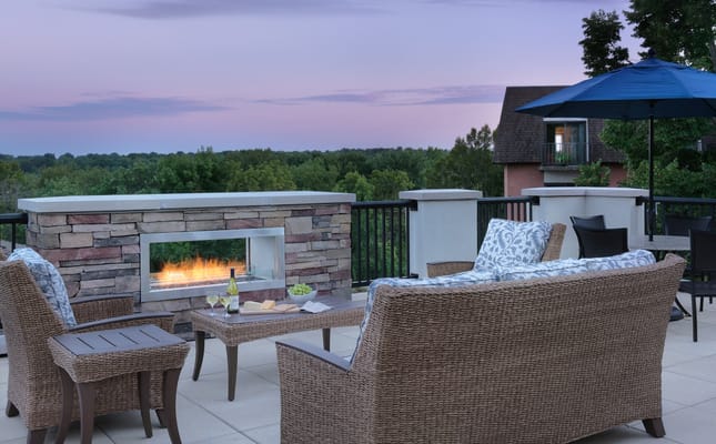 Outdoor seating area with a fireplace and view