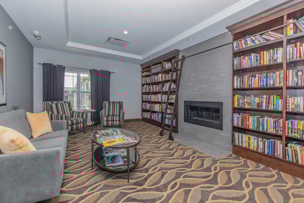 Cozy library area with bookshelves and seating