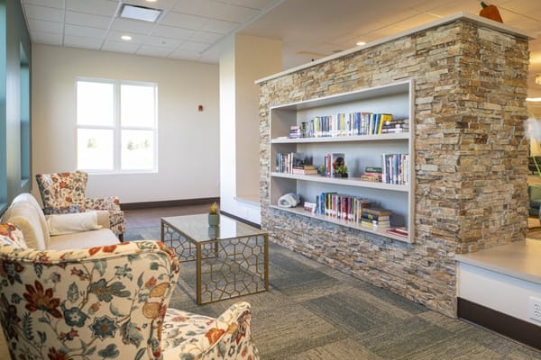 Common area with seating and bookshelf