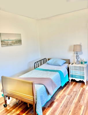 Cozy private resident room with bed and lamp