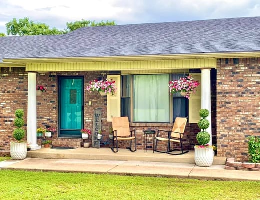 Welcoming porch area with flowers and seating