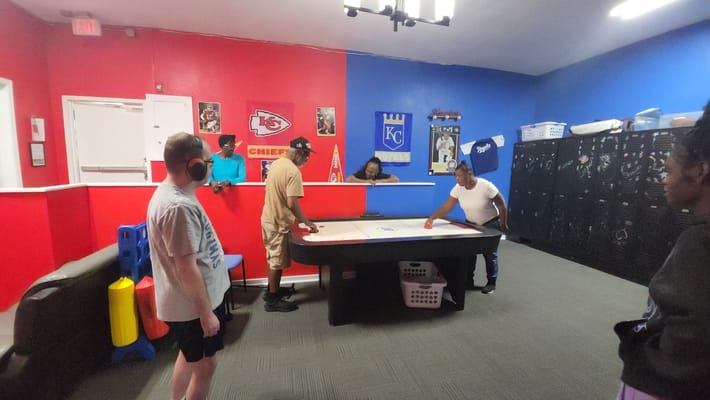 Residents engaging in a game activity in a common area