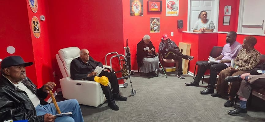 Residents gathered in a common area with red walls