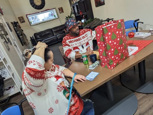 Residents celebrating with festive sweaters at a table