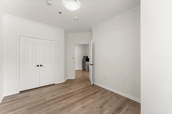 Empty private resident room with light wood flooring