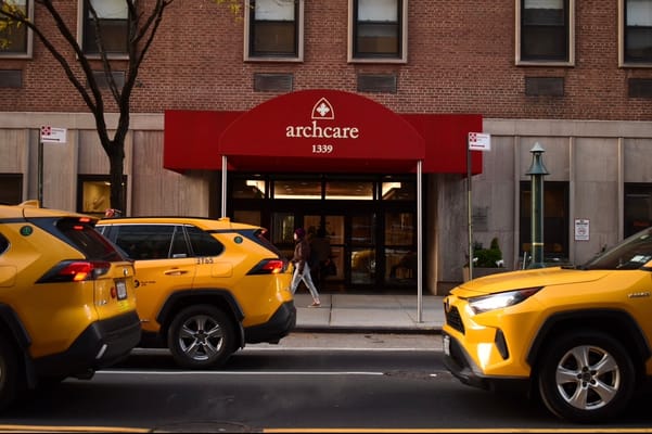 Exterior view of ArchCare facility with taxis in front