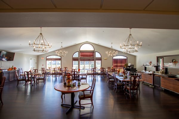 Dining area with tables and chairs set for meals
