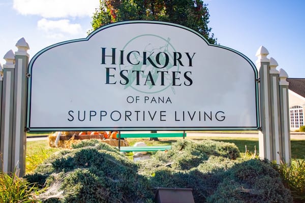 Sign displaying Hickory Estates of Pana branding