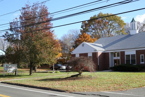 Exterior view of Orchard House facility with seasonal foliage