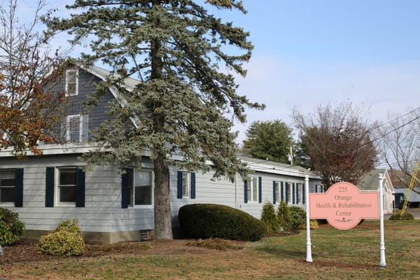 Exterior view of Orange Health care facility with sign