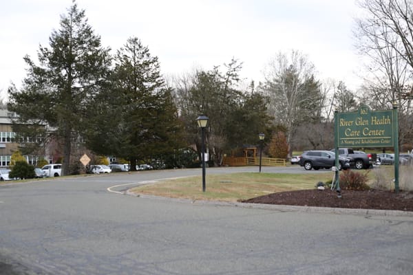 Sign for River Glen Health Care Center at entrance