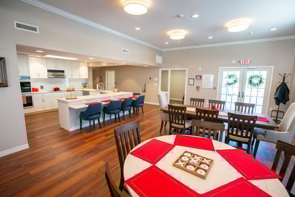 Bright common area with dining tables and chairs