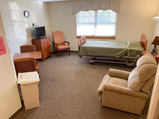 Interior of a resident room with a bed and seating