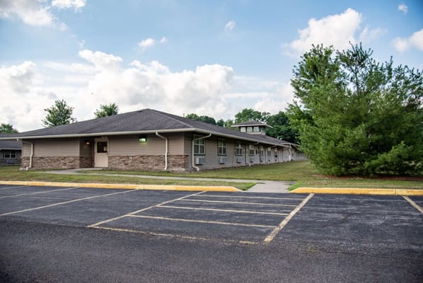 Exterior view of the assisted living facility with gardens