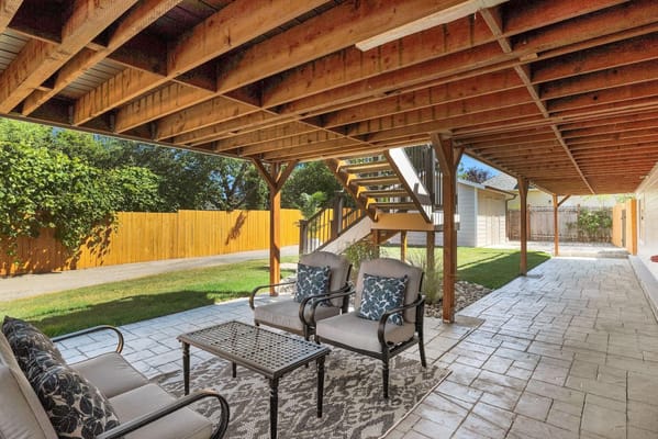 Outdoor patio area with seating and greenery