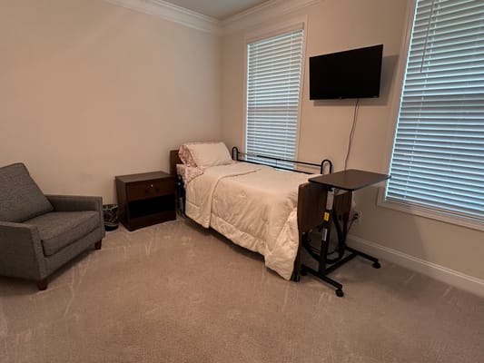 Interior of a resident room with bed and chair