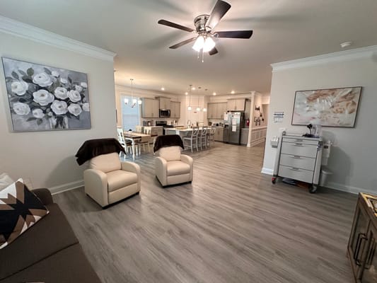Bright common area with seating and kitchen view