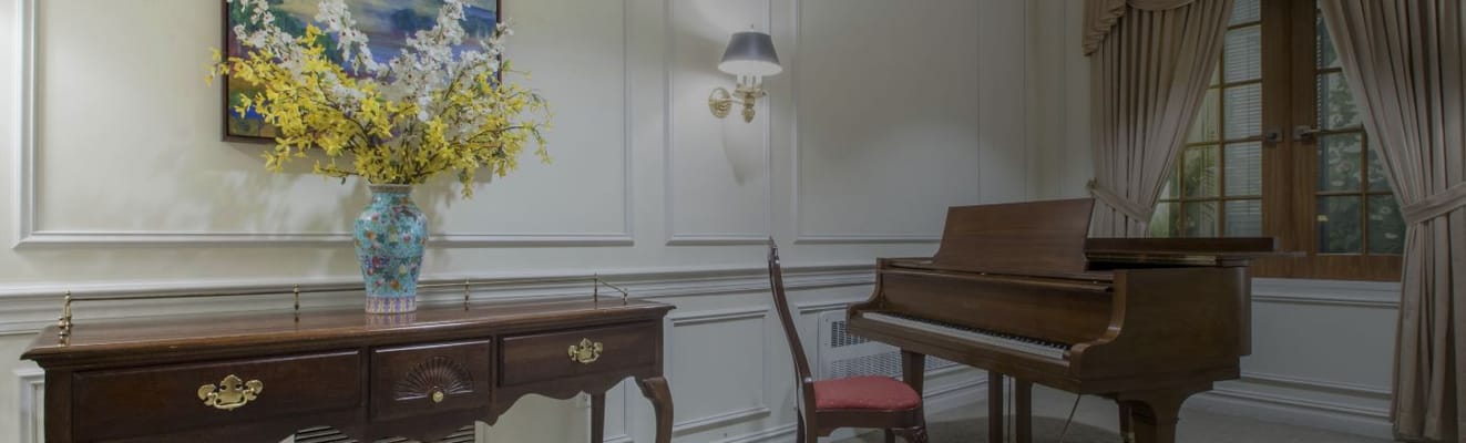 Cozy interior with a piano and decorative flowers