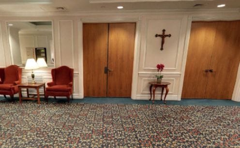 Common area with chairs and decorative cross